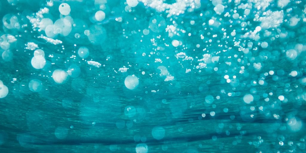 underwater photography of water bubbles
