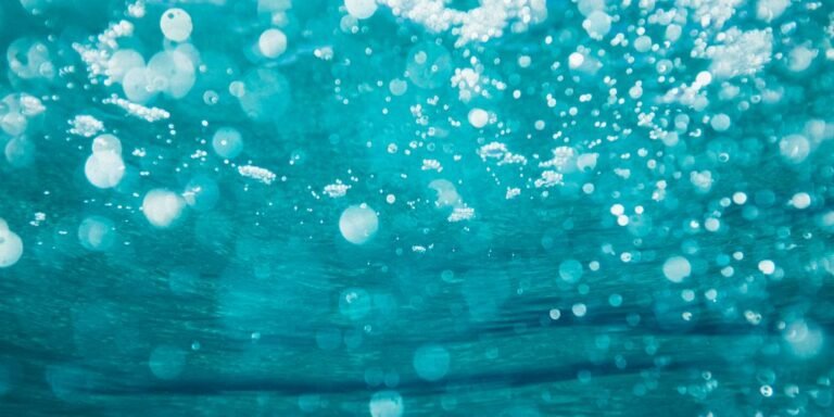 underwater photography of water bubbles